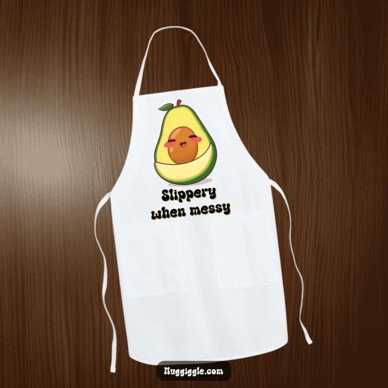 Funny Avocado Apron: A clumsy green avocado character comically slipping on its own peel, a humorous kitchen accessory for cooking.