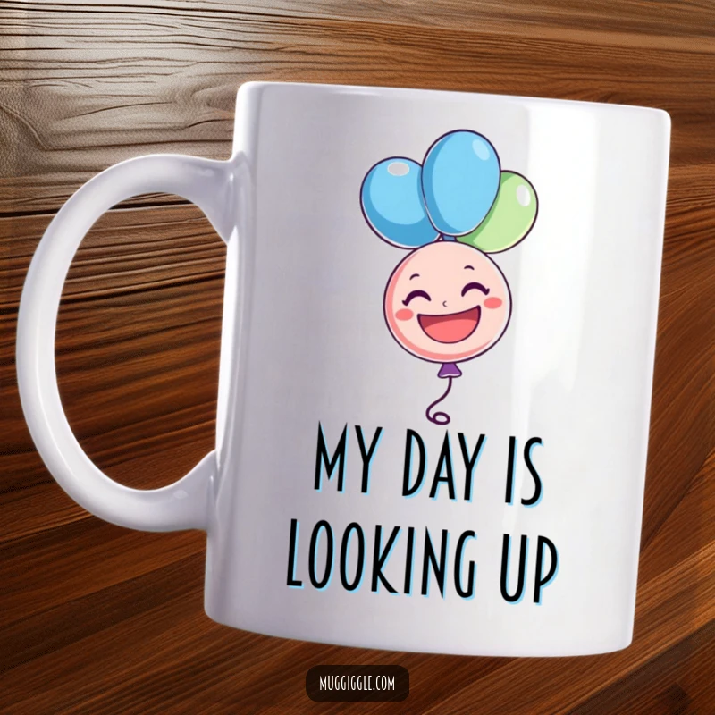 Funny balloon mug showing a cheerful character floating upside down with a big grin, radiating happiness and making a great funny gift.