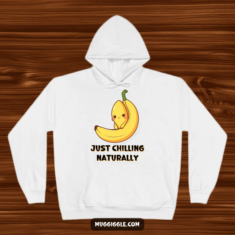 Funny hoodie featuring a curious banana character peeking out from an empty banana peel, embodying cozy humor and fruity charm.