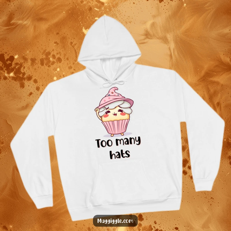 Funny hoodie print of a cute, flustered cupcake character comically overloaded with too many hats.